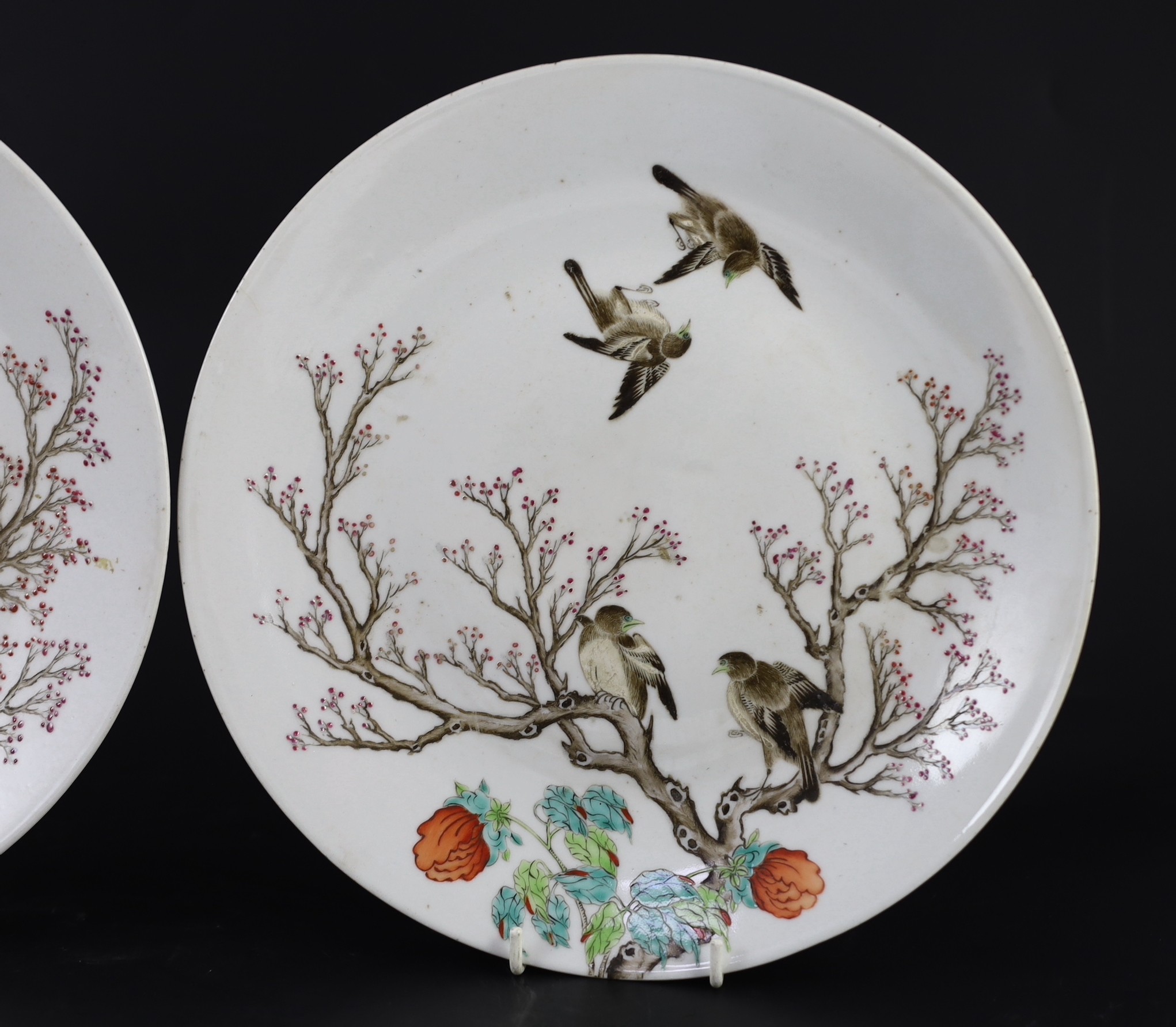 A pair of Chinese enamelled porcelain 'blackbird' dishes, Qianlong seal marks but 19th century, 27cm diameter, minor damage